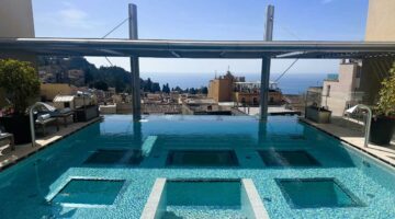 NH Collection Taormina pool deck overlooking the town